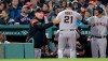 San Francisco Giants' Stephen Vogt (21) gets a pat on the back from manager Bruce Bochy, left, after his sacrifice that scored Kevin Pillar during the eighth inning of a baseball game against the Boston Red Sox at Fenway Park in Boston, Wednesday, Sept. 18, 2019. (AP Photo/Charles Krupa)