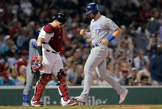 Kansas City Royals' Hunter Dozier (17) scores on a double by Nicky Lopez during the seventh inning against the Boston Red Sox in a baseball game at Fenway Park in Boston, Wednesday, Aug. 7, 2019. At left is Red Sox catcher Christian Vazquez. (AP Photo/Charles Krupa)