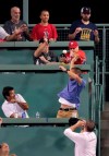 Fans duck for cover from the incoming ball on a two run home run by Philadelphia Phillies' Bryce Harper in the fifth inning during a baseball game against the Boston Red Sox at Fenway Park in Boston, Wednesday, Aug. 21, 2019. (AP Photo/Charles Krupa)