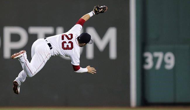 Boston Red Sox second baseman Michael Chavis (23) makes a diving catch of a fly ball by Kansas City Royals' Hunter Dozier during the eighth inning of a baseball game at Fenway Park in Boston, Tuesday, Aug. 6, 2019. (AP Photo/Charles Krupa)