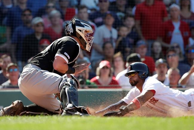 Boston Red Sox's Eduardo Nunez slides safely into home to score on a fielder's choice grounder by Mookie Betts as Chicago White Sox catcher James McCann can't make the tag in the eighth inning of a baseball game at Fenway Park, Wednesday, June 26, 2019, in Boston. (AP Photo/Elise Amendola)
