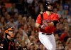 Boston Red Sox's Mitch Moreland watches his RBI triple in front of Baltimore Orioles catcher Chance Sisco during the fourth inning of a baseball game at Fenway Park, Friday, Aug. 16, 2019, in Boston. (AP Photo/Elise Amendola)