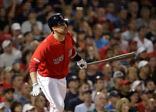 Boston Red Sox's J.D. Martinez watches his two-run home run during the fourth inning of the team's baseball game against the Los Angeles Angels at Fenway Park, Friday, Aug. 9, 2019, in Boston. (AP Photo/Elise Amendola)