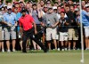 Tiger Woods, foreground left, reacts after his chip onto the green failed to drop into the hole on the seventh green during the final round of the Deutsche Bank Championship PGA golf tournament at TPC Boston in Norton, Mass., Monday, Sept. 3, 2012. (AP Photo/Michael Dwyer)