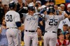 New York Yankees' Gleyber Torres (25) celebrates his two-run home with Luke Voit, center, that also drove in Edwin Encarnacion during the second inning of a baseball game against the Boston Red Sox in Boston, Sunday, Sept. 8, 2019. (AP Photo/Michael Dwyer)