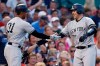 New York Yankees' Austin Romine, right, celebrates his two-run home run with Aaron Hicks (31) during the third inning of a baseball game against the Boston Red Sox in Boston, Sunday, July 28, 2019. (AP Photo/Michael Dwyer)