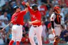 Boston Red Sox's Sam Travis, center, celebrates his solo home run with Christian Vazquez (7) as Baltimore Orioles' Chance Sisco, right, looks away during the fourth inning of a baseball game in Boston, Sunday, Aug. 18, 2019. (AP Photo/Michael Dwyer)