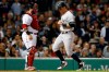 New York Yankees' Mike Tauchman, right, scores in front of Boston Red Sox's Sandy Leon on an RBI-single by Aaron Judge during the third inning of a baseball game in Boston, Sunday, Sept. 8, 2019. (AP Photo/Michael Dwyer)