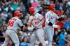 Los Angeles Angels' Mike Trout (27) celebrates his two-run home run that also drove in Kole Calhoun (56) as Shohei Ohtani comes to bat during the sixth inning of a baseball game against the Boston Red Sox in Boston, Saturday, Aug. 10, 2019. (AP Photo/Michael Dwyer)