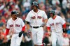 Boston Red Sox's Xander Bogaerts, center, celebrates his three-run home run that also drove in Mookie Betts, left, and J.D. Martinez, right, during the eighth inning of a baseball game against the Baltimore Orioles in Boston, Sunday, April 14, 2019. (AP Photo/Michael Dwyer)