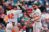 Baltimore Orioles' Chris Davis, right, celebrates his two-run home run that also drove in Renato Nunez, left, during the eighth inning of a baseball game against the Boston Red Sox in Boston, Monday, April 15, 2019. (AP Photo/Michael Dwyer)