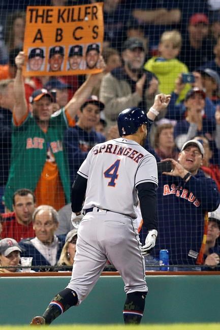 Houston Astros fans celebrate a two-run home run by George Springer (4) during the eighth inning of the team's baseball game against the Boston Red Sox in Boston, Friday, May 17, 2019. (AP Photo/Michael Dwyer)