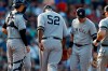 New York Yankees' CC Sabathian leaves the mound after being removed by manger Aaron Boone, behind left, during the fifth inning of a baseball game against the Boston Red Sox in Boston, Saturday, July 27, 2019. (AP Photo/Michael Dwyer)