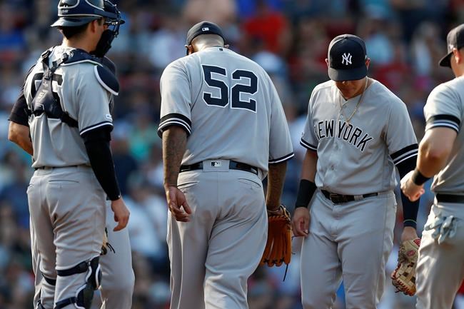 New York Yankees' CC Sabathian leaves the mound after being removed by manger Aaron Boone, behind left, during the fifth inning of a baseball game against the Boston Red Sox in Boston, Saturday, July 27, 2019. (AP Photo/Michael Dwyer)