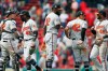Baltimore Orioles' Miguel Castro, center, and Jesus Sucre, left, celebrate with teammates after defeating the Boston Red Sox during a baseball game in Boston, Monday, April 15, 2019. The players are all wearing (42) in honor of Jackie Robinson Day.(AP Photo/Michael Dwyer)