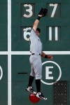 New York Yankees' Mike Tauchman can not make the catch on the RBI triple by Boston Red Sox's Jackie Bradley Jr. during the sixth inning of a baseball game in Boston, Saturday, July 27, 2019. (AP Photo/Michael Dwyer)