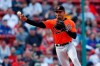 Baltimore Orioles' Richie Martin throws to first base on a ground out by Boston Red Sox's Dustin Pedroia during the ninth inning of a baseball game in Boston, Saturday, April 13, 2019. (AP Photo/Michael Dwyer)