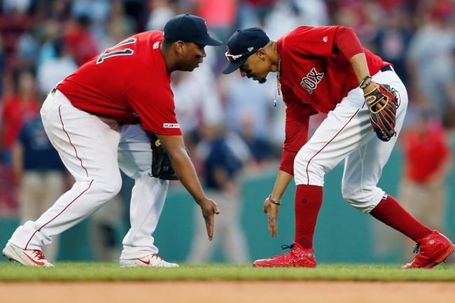 Boston Red Sox's Mookie Betts, right, and Rafael Devers celebrate after defeating the New York Yankees during a baseball game in Boston, Saturday, July 27, 2019. (AP Photo/Michael Dwyer)