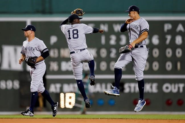New York Yankees' Aaron Judge, right, and Didi Gregorius celebrate after defeating the Boston Red Sox during a baseball game in Boston, Sunday, Sept. 8, 2019. (AP Photo/Michael Dwyer)