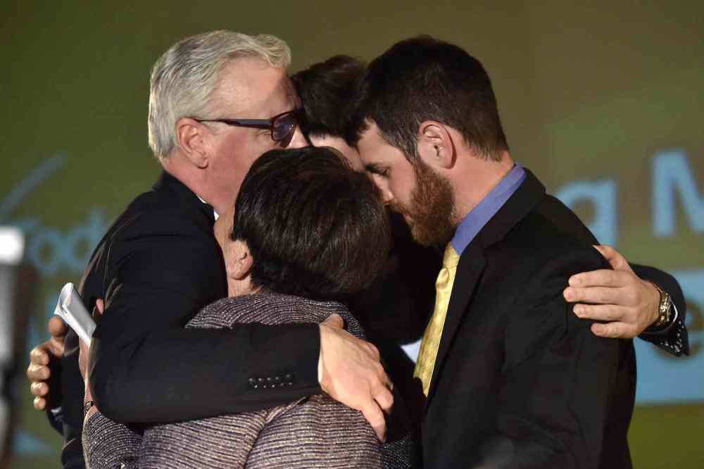 (MIKE SUDOMA / THE CANADIAN PRESS) Manitoba NDP leader Greg Selinger hugs his family on stage at his party's post-election gathering in Winnipeg.