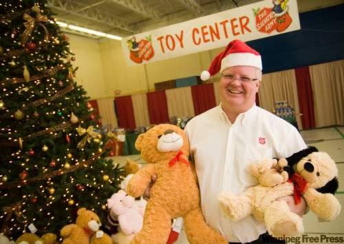 DAVID LIPNOWSKI / WINNIPEG FREE PRESS
Salvation Army Weetamah Centre ministry director Mark Young cuddles a couple of furry companions Tuesday at Toy Mountain, the Sally Ann toy depot at 324 Logan Ave.