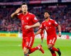 Munich's Robert Lewandowski,left, celebrates his side's third goal during the German Soccer Cup match between FC Bayern Munich and 1. FC Heidenheim in Munich, Germany, Wednesday, April 3, 2019. (AP Photo/Matthias Schrader)