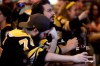 Boston Bruins fan Adam Aldred, front, of Foxborough, Mass., rests his head on his hand at a Boston bar, after the St. Louis Blues defeated the Bruins 4-1 in Game 7 of the NHL hockey Stanley Cup Final, Wednesday, June 12, 2019. (AP Photo/Steven Senne)