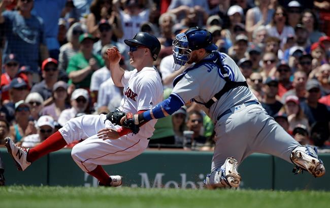 Boston Red Sox's Brock Holt, left, is tagged out by Toronto Blue Jays' Danny Jansen, right, as he attempts to score on a single by Red Sox's Jackie Bradley Jr. in the second inning of a baseball game in Boston, Sunday, June 23, 2019. (AP Photo/Steven Senne)