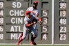 Los Angeles Angels' Brian Goodwin, behind, catches a fly ball by Boston Red Sox's Chris Owings as Angels' David Fletcher, front, scrambles in the sixth inning of a baseball game at Fenway Park, Sunday, Aug. 11, 2019, in Boston. (AP Photo/Steven Senne)