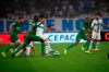 Marseille's Dario Benedetto, right, battles for the ball with Saint-Etienne's Jean-Eudes Aholou, center, and Saint-Etienne's Mathieu Debuchy during the French League One soccer match between Marseille and Saint-Étienne at the Velodrome stadium in Marseille, southern France, Sunday, Sept. 1, 2019. (AP Photo/Daniel Cole)