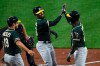 Oakland Athletics' Marcus Semien, center is congratulated by Jurickson Profar, right, and Josh Phegley after hitting a three run home run in the third inning of a baseball game, Tuesday, April 9, 2019, in Baltimore. (AP Photo/Gail Burton)