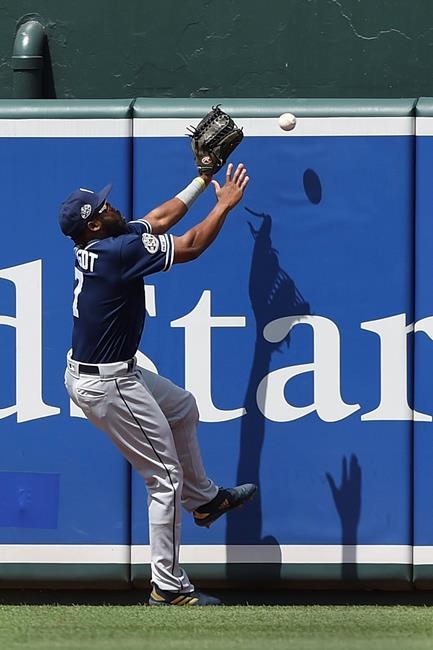 San Diego Padres' Manuel Margot reaches for a ball hit by Baltimore Orioles' Hanser Alberto in the first inning of a baseball game Wednesday, June 26, 2019, in Baltimore. Alberto earned a triple on the play.(AP Photo/Gail Burton)