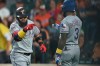 Texas Rangers Rougned Odor, left, motions to Delino DeShields after hitting a three-run home run against the Baltimore Orioles in the first inning of a baseball game, Saturday, Sept. 7, 2019, in Baltimore. (AP Photo/Gail Burton)