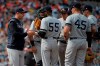 New York Yankees starting pitcher Domingo German (55) is pulled from the game by manager Aaron Boone, left, during the seventh inning of the team's baseball game against the Baltimore Orioles, Sunday, April 7, 2019, in Baltimore. (AP Photo/Will Newton)