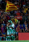 Betis' players celebrate after his teammate Betis' Nabil Fekir scores his side's first goal during the Spanish La Liga soccer match between FC Barcelona and Betis at the Camp Nou stadium in Barcelona, Spain, Sunday, Aug. 25, 2019. (AP Photo/Joan Monfort)