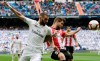 Real Madrid's Karim Benzema, left, vies for the ball with Athletic Bilbao's Inigo Martinez during a Spanish La Liga soccer match between Real Madrid and Athletic Bilbao at the Santiago Bernabeu stadium in Madrid, Spain, Sunday, April 21, 2019. (AP Photo/Bernat Armangue)