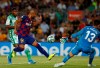Barcelona's Rafinha, second left, kicks the ball next to Betis' goalkeeper Dani Martin, right, during the Spanish La Liga soccer match between FC Barcelona and Betis at the Camp Nou stadium in Barcelona, Spain, Sunday, Aug. 25, 2019. (AP Photo/Joan Monfort)