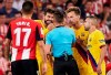 Barcelona's Gerard Pique, second left, talks with the referee during the Spanish La Liga soccer match between Athletic Bilbao and FC Barcelona at San Mames stadium in Bilbao, northern Spain, Friday, Aug. 16, 2019. (AP Photo/Ion Alcoba Beitia)