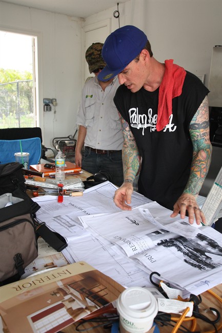 This July 1, 2011 photo provided by the DIY Network, shows singer Rob Van Winkle, also know as Vanilla Ice, as he reviews plans of a home he's remodeling in Wellington, Fla. After Van Winkle's early 1990 stardom faded, he became heavily involved in real estate. Winkle is starting in