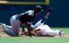 Detroit Tigers' Josh Harrison, right, is tagged out by Chicago White Sox shortstop Tim Anderson, left, on an attempted steal during the first inning of a baseball game, Sunday, April 21, 2019, in Detroit. (AP Photo/Carlos Osorio)
