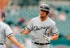 Chicago White Sox's Jose Abreu is greeted by third base coach Nick Capra after a solo home run during the first inning of the first game of a baseball doubleheader against the Detroit Tigers, Tuesday, Aug. 6, 2019, in Detroit. (AP Photo/Carlos Osorio)