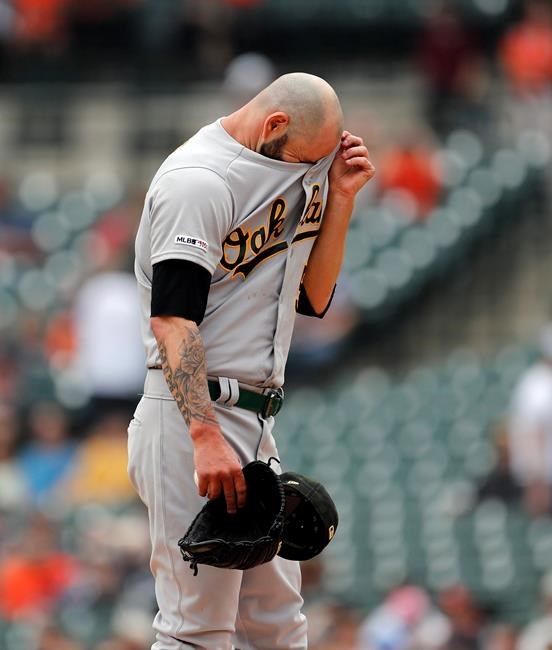 Oakland Athletics starting pitcher Mike Fiers wipes his forehead during the first inning of a baseball game against the Detroit Tigers, Sunday, May 19, 2019, in Detroit. (AP Photo/Carlos Osorio)