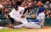 Kansas City Royals' Kelvin Gutierrez beats the tag of Detroit Tigers third baseman Jeimer Candelario for an RBI triple during the fourth inning of a baseball game Friday, May 3, 2019, in Detroit. (AP Photo/Carlos Osorio)