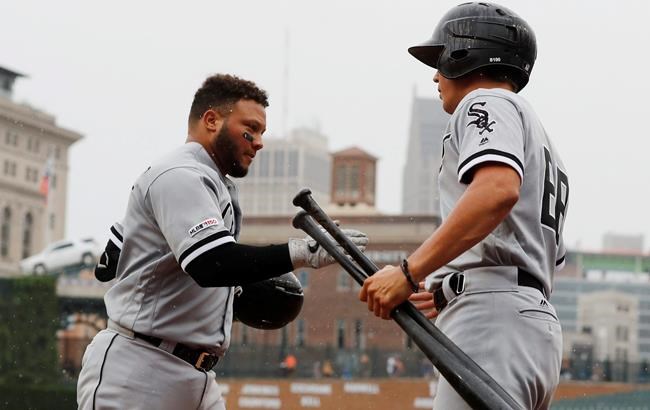 Chicago White Sox's Welington Castillo, left, is greeted at the dugout after a solo home run during the sixth inning of the first game of a baseball doubleheader against the Detroit Tigers, Tuesday, Aug. 6, 2019, in Detroit. (AP Photo/Carlos Osorio)