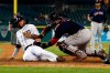 Detroit Tigers' Harold Castro, left, safely beats the tag of Boston Red Sox catcher Sandy Leon to score during the sixth inning of a baseball game, Friday, July 5, 2019, in Detroit. (AP Photo/Carlos Osorio)