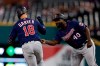 Minnesota Twins' Mitch Garver is greeted by first base coach Tommy Watkins after a solo home run during the ninth inning of a baseball game Saturday, Aug. 31, 2019, in Detroit. Garver's home run was the Twins 268th home run of this season, a MLB record for most home runs by a team in a single season. (AP Photo/Carlos Osorio)