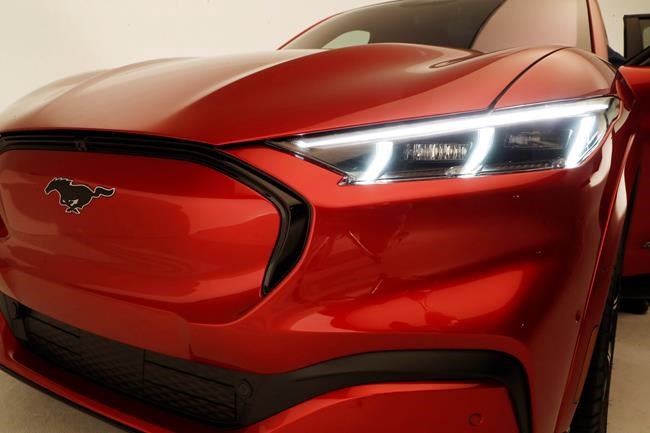 This Wednesday, Oct. 30, 2019 photo shows the front headlights of the new Ford Mustang Mach-E SUV in Warren, Mich. Ford is hoping to score big with the electric SUV for daily drivers that sort of looks like a Mustang performance car. The new SUV, to be unveiled just ahead of the Los Angeles Auto Show press days, should have range of up to 300 miles. It's one of dozens of electric vehicles coming globally by 2022. Automakers are eyeing what they think will be a growing market in the years to come. (AP Photo/Carlos Osorio)