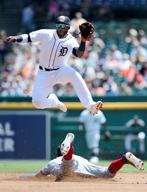 Detroit Tigers shortstop Niko Goodrum jumps above Washington Nationals' Trea Turner in an attempt to catch a high throw on a pickoff attempt during the first inning of a baseball game Sunday, June 30, 2019, in Detroit. The ball was fielded by second baseman Gordon Beckham. (AP Photo/Duane Burleson)