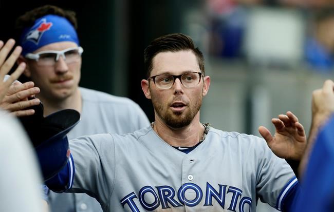 Toronto Blue Jays' Eric Sogard celebrates after scoring on a wild pitch by Detroit Tigers' Jordan Zimmermann during the first inning of a baseball game, Friday, July 19, 2019, in Detroit. (AP Photo/Duane Burleson)