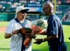 Minnie Forbes, former owner of the Detroit Stars of the Negro Leagues, is presented with flowers by former Detroit Tiger Jake Wood, right, during a celebration of the Negro Leagues before the Tigers' baseball game against the Kansas City Royals on Saturday, Aug. 10, 2019, in Detroit. (AP Photo/Duane Burleson)